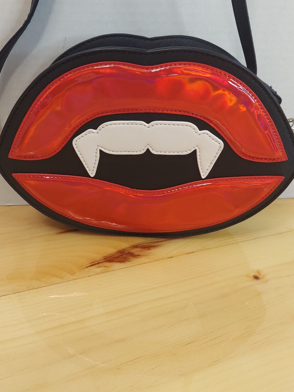 Mad Engine vampire lips crossbody bag featuring glossy red lips